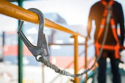 Person using harness and lanyard to prevent falling