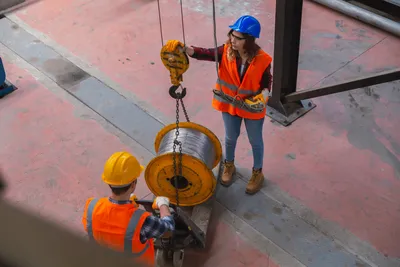 Overhead crane training. female lifting a coil of wire