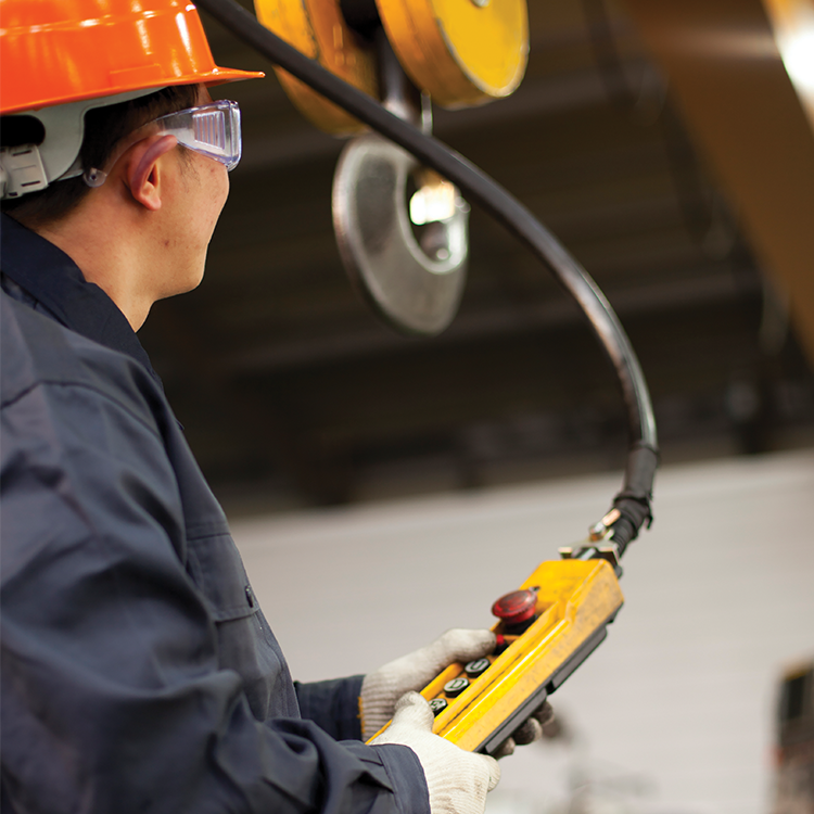 person learning how to use an overhead travelling crane on training