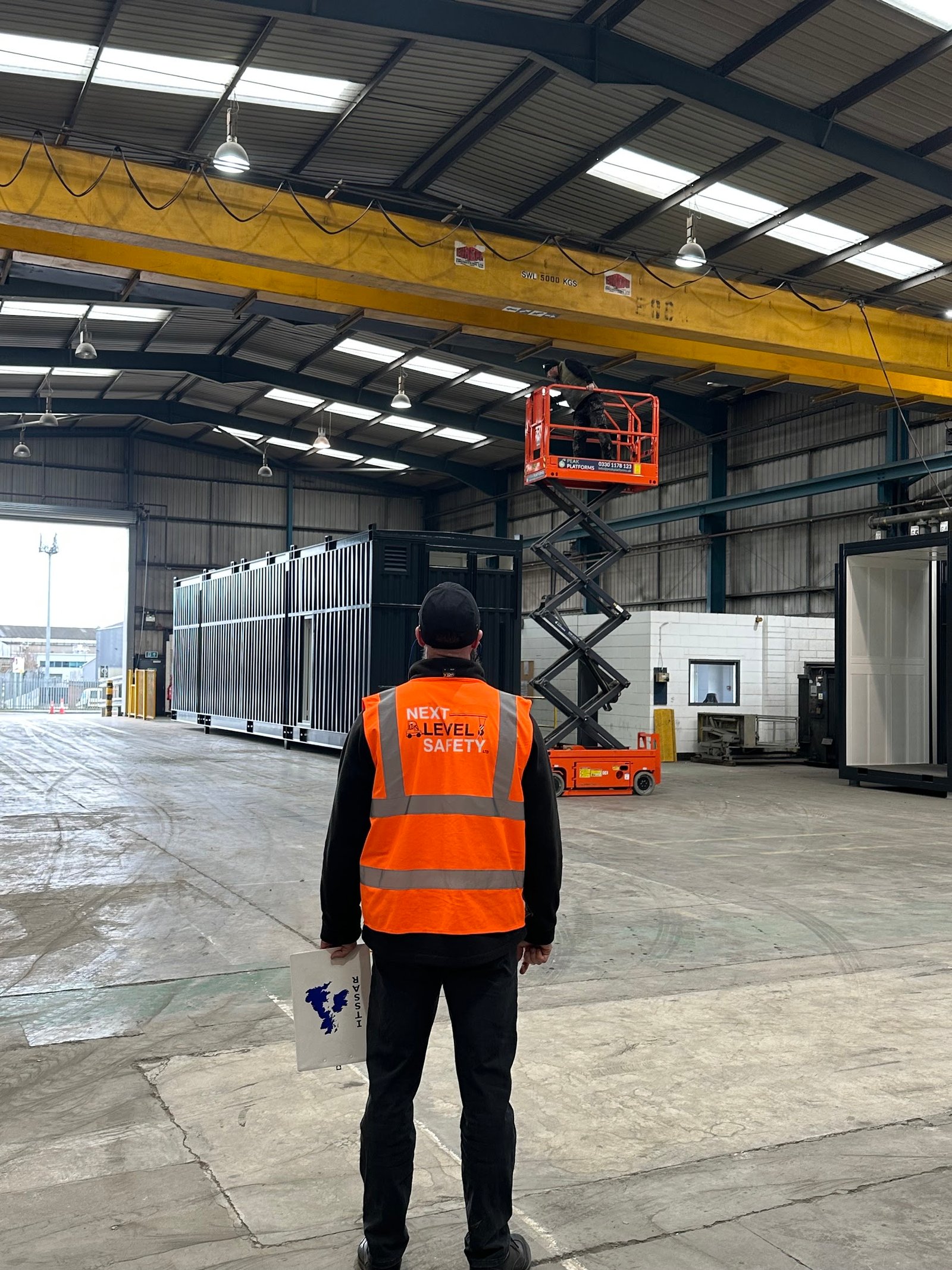 IPAF scissor lift training. an operator in a scissor lift carrying out a test